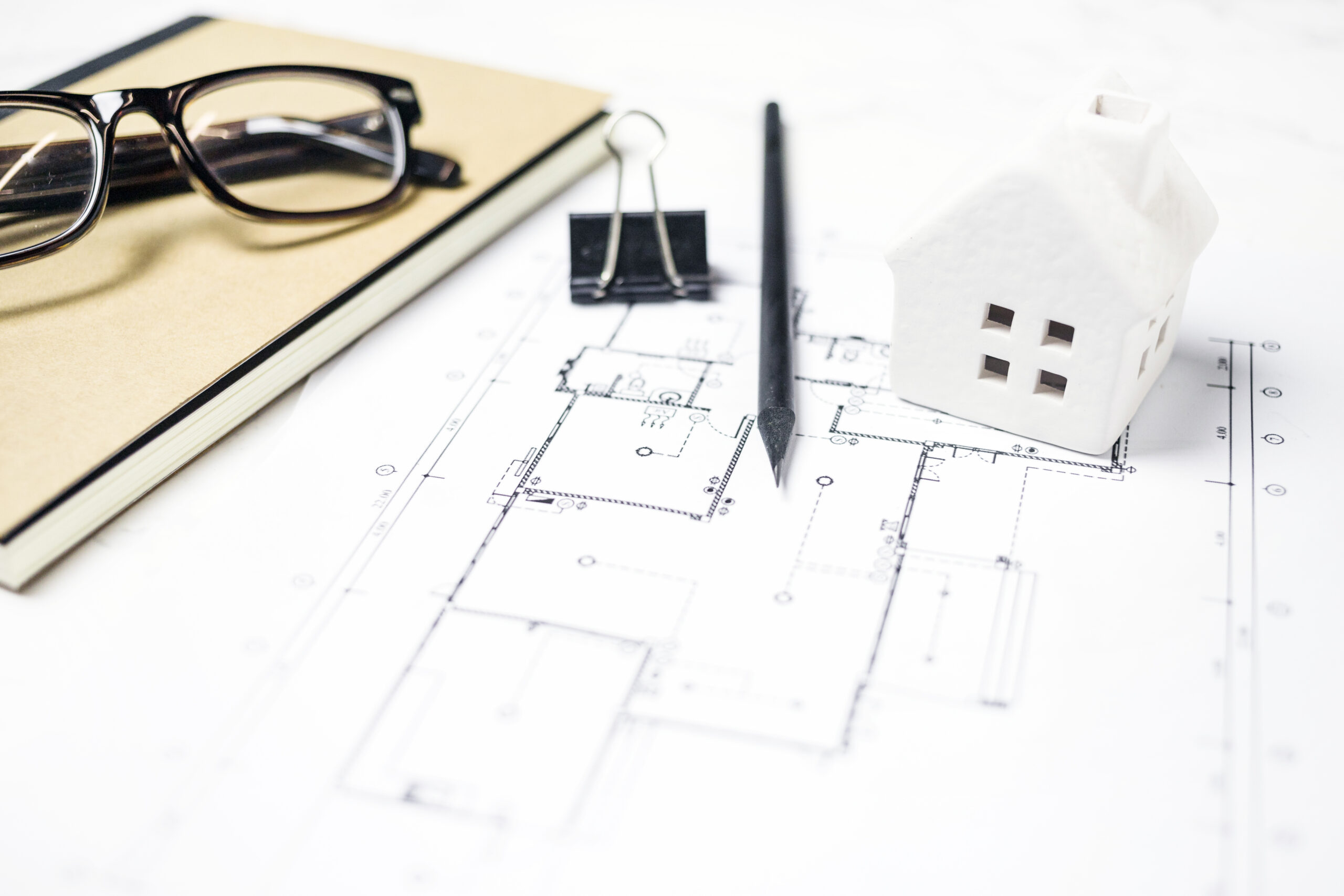 casa-de-juguete-y-gafas-cerca-de-papeleria-y-planos